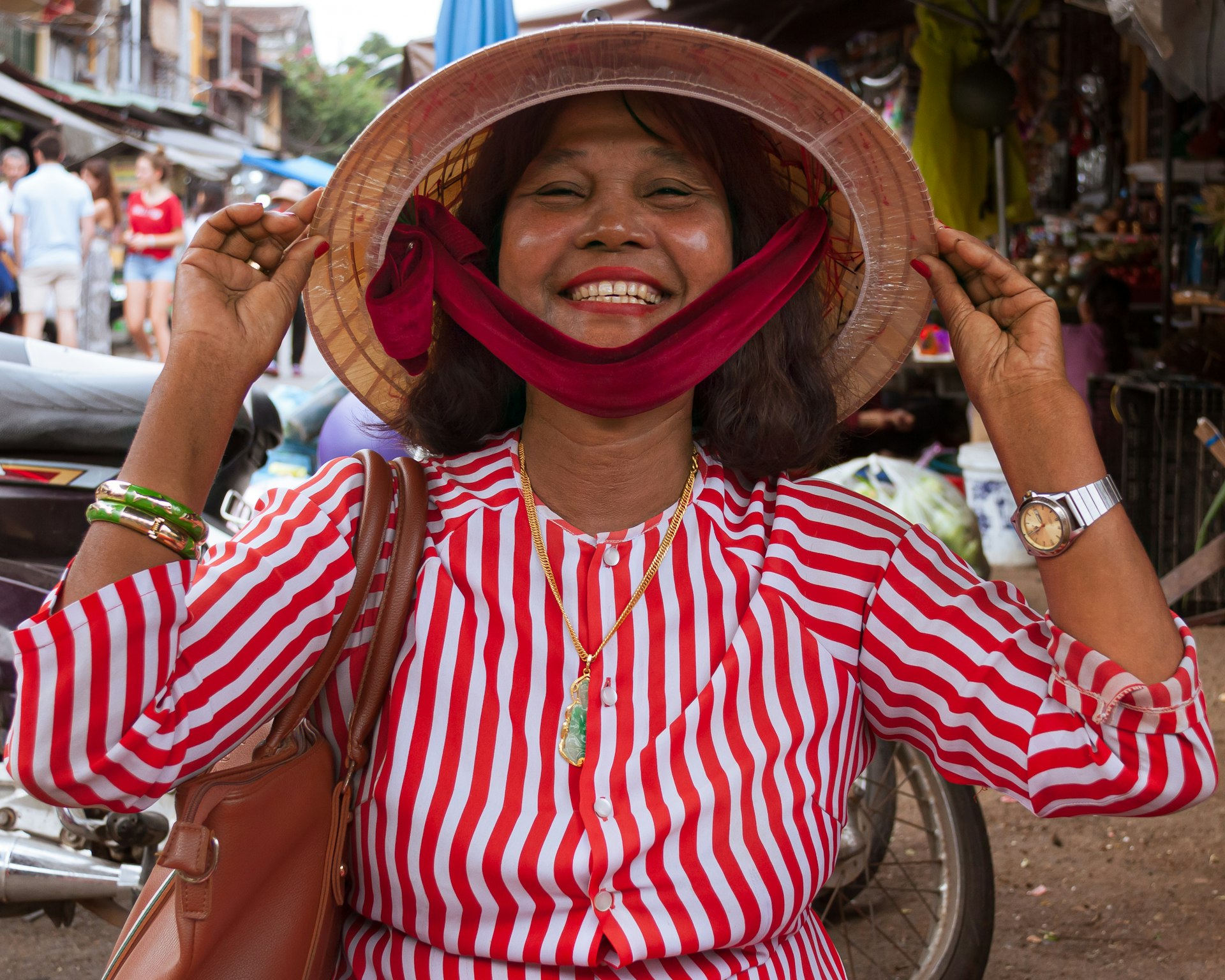 woman in red and white stripe long sleeve shirt wearing brown hat